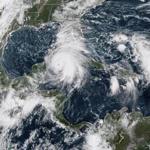 This NOAA/RAMMB satellite image taken on October 8, 2018 at 14:30 UTC shows Tropical storm Michael off the US Gulf Coast. - Tropical storm Michael was upgraded to a Category 1 hurricane on October 8, 2018 as it barreled toward the US Gulf Coast packing maximum sustained winds of 75 miles per hour, meteorologists said.The weather system was located between Mexico's Yucatan peninsula and the west coast of Cuba by 1500 GMT and was heading slowly towards the northern Gulf Coast of Florida, the National Hurricane Center in Miami said.It is expected to hit major hurricane strength and move inland over the Florida Panhandle or Florida Big Bend area on Wednesday, and then northeastward across the southeastern United States through Thursday. (Photo by HO / NOAA/RAMMB / AFP) / RESTRICTED TO EDITORIAL USE - MANDATORY CREDIT 