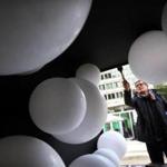 Artist Philippe Morvan worked on his installation ?Glow-Bulles? at the Container Village at City Hall Plaza, where the fourth annual HUBweek festival kicked off on Monday. 