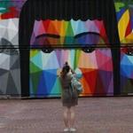 A woman stopped to take a photo of the feature wall painted by Okuda San Miguel.