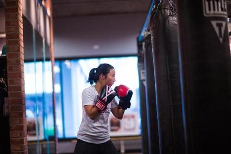 Jungeun Lee, a senior accountant at Corbus Pharmaceuticals practices her form during a boxing class at TITLE Boxing Club in Norwood., Tuesday, Oct. 9. 2018. Gretchen Ertl for The Boston Globe.

