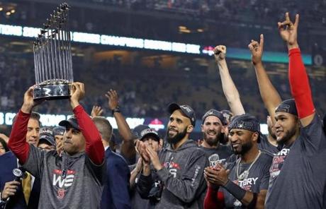 Alex Cora hoisted the World Series trophy.
