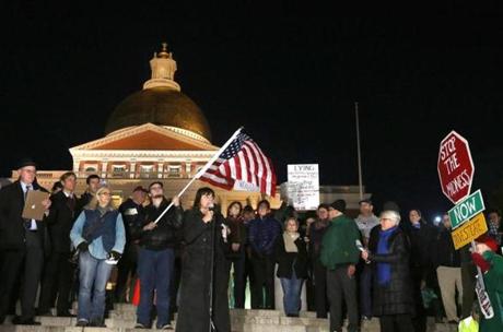 Middlesex District Attorney Marian Ryan (cq) is one of the speakers. (Suffolk University student Scott Damon (cq), 21, holds the flag behind her.) People hold a protest to protect the Mueller investigation, on Boston Common, across from the State House.
