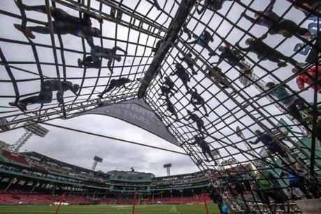 As a part of the Spartan Race over the weekend, participants scaled a ropes obstacle in the outfield of Fenway Park. 
