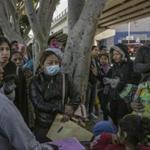 Mothers talk with each other after getting a number to apply for asylum, in Tijuana, Mexico, by the entrance to the border with the United States, Nov. 17, 2018. A federal judge on Nov. 20 ordered the Trump administration to resume accepting asylum claims from migrants no matter where or how they entered the U.S., dealing at least a temporary setback to the president?s attempt to clamp down on a huge wave of Central Americans crossing the border. (Mauricio Lima/The New York Times)