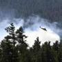 LB Test: Description/Caption: This April 30, 2018 photo provided by the U.S. Forest Service shows a helicopter fighting a wildfire in north-central Arizona. Fire officials say higher humidity and expected cloud cover Tuesday, May 1, 2018, should help nearly 600 firefighters battling the blaze. (U.S. Forest Service, Coconino National Forest via AP) 