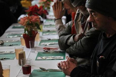 Boston, Ma., 12/24/2018, Cardinal Sean O'Malley said grace for the men at the Pine Street Inn holiday luncheon. A holiday luncheon was served to residents and guests of the Pine Street Inn. Over 1,000 meals were prepared and served to men and women at various locations throughout the city. Suzanne Kreiter/Globe staff 

