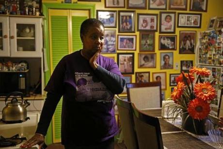 Cambridge, MA, 01/14/2019 -- Marcelle Harrison listens as she chats with neighbors inside the kitchen of her home at 6 Ashburton Place where she has lived since the late 70's. She and her family are facing eviction from the house because distant relatives from Barbados have laid claim to the home. Massachusetts law allows for direct descendants to inherit property of anyone who didn't leave a will. Topic: 17cambridge Reporter: 
