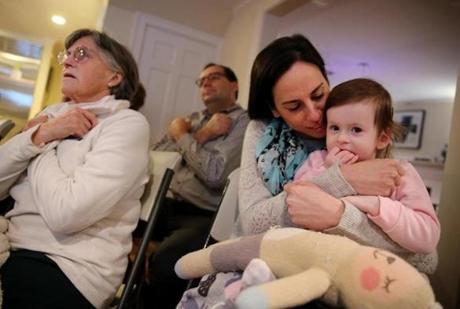Glenda Savitz held her 2-year-old daughter, Samantha, while signing the word 