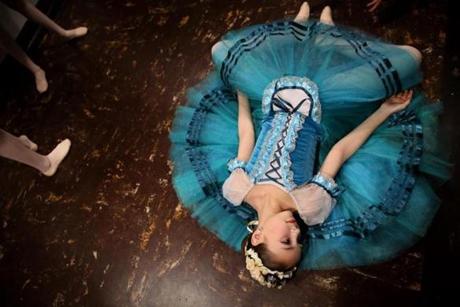 Boston, MA - February 07, 2019: Kendall Case, 11, stretches on the floor while preparing to perform in the Pre-Competitive Classical Competition of the Youth America Grand Prix at John Hancock Hall in Boston, MA on February 07, 2019. Hundreds of ballet dancers from all over New England, ages 9 to 19, will be auditioning for the Youth America Grand Prix (YAGP) throughout the weekend. Students will be competing with the hope of advancing to Finals Week in New York City in April, where scholarships will be awarded. (For the past 20 years YAGP has awarded more than $250,000 annually in scholarships to send up-and-coming dancers to prestigious schools and companies around the globe. YAGP Alumni have gone on to join American Ballet Theatre, Paris Opera Ballet, Dutch National Ballet, New York City Ballet, among others! This year's international semi-finals held auditions in Brazil, Korea, Australia, Japan, Italy, France and Spain. National semi-finals include 22 cities across North America including Los Angeles, Toronto, Denver, Philadelphia, Salt Lake City, Tampa, Chicago, Dallas, Boston and Atlanta. A full list can be found at www.YAGP.org. ) (Craig F. Walker/Globe Staff) section: Metro reporter:
