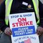 Stop & Shop employee Rohan Balbour held a strike placard outside the store on Freeport Street in Dorchester on Thursday.