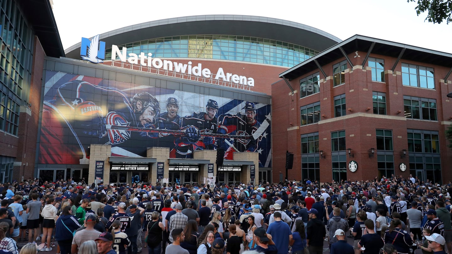 Fans gather for a candlelight vigil to honor Columbus Blue Jackets hockey player Johnny Gaudreau outside of Nationwide Arena on Wednesday.