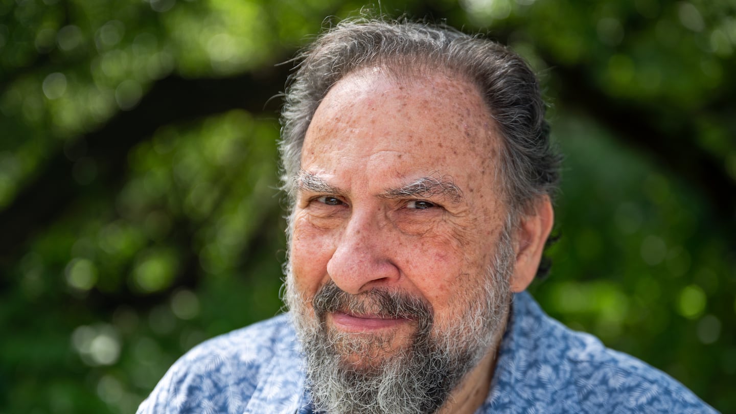 Moshe Waldoks poses for a portrait during a walk along the Charles River in Allston in late August. Waldoks's one-man show, "You Can Live If They Let You," premieres at Boston Center for the Arts Sept. 12.