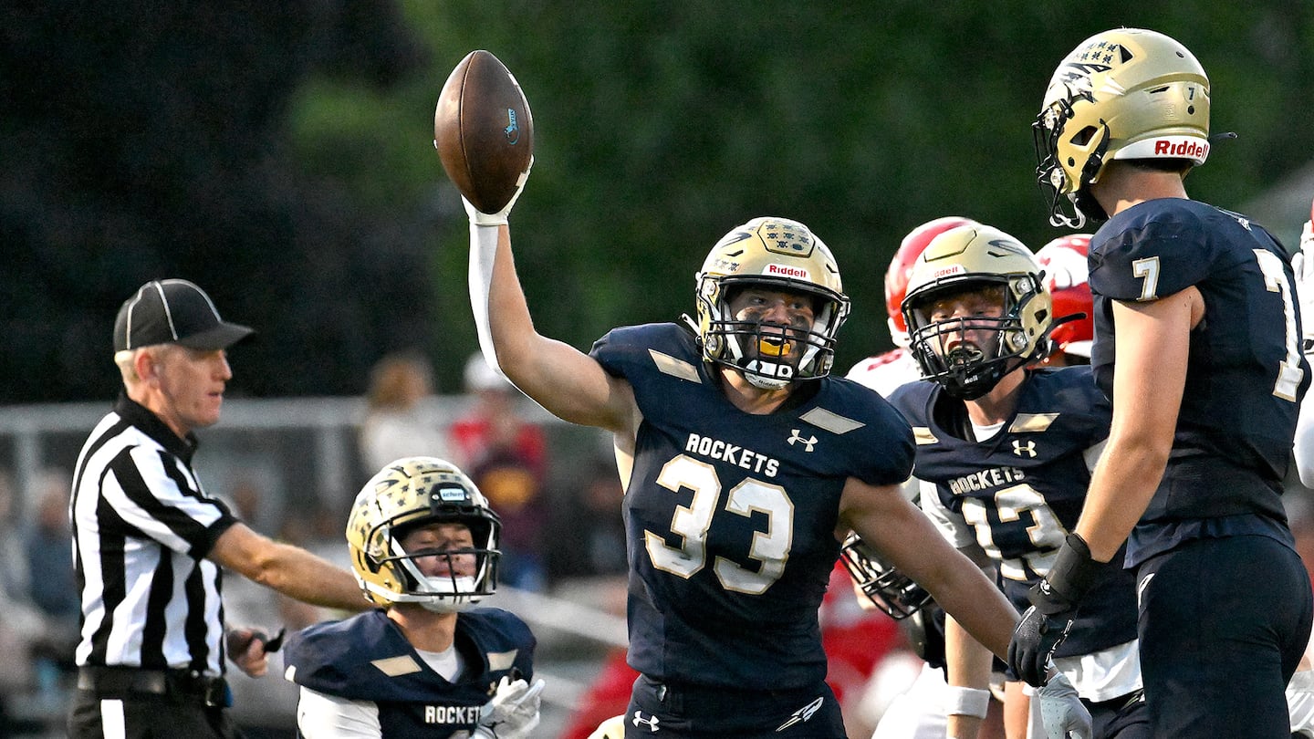 Needham’s Joe Kajunski (33) showed off his fumble recovery in the first half of the Rockets' 24-0 Bay State Conference win over Milton.