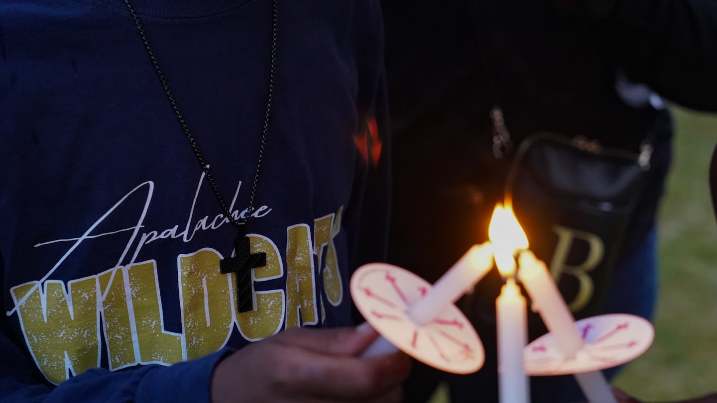 Community members, students, and faculty of Apalachee High School come together for a vigil on Sept. 6, in Monroe, Ga.