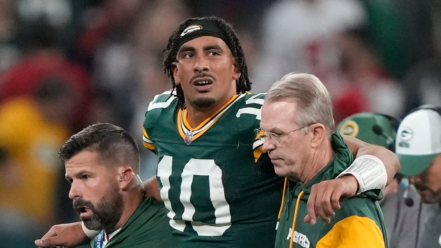 Packers quarterback Jordan Love is helped off the field after getting hurt in the final seconds of Friday night's loss to the Eagles in Sao Paulo, Brazil.