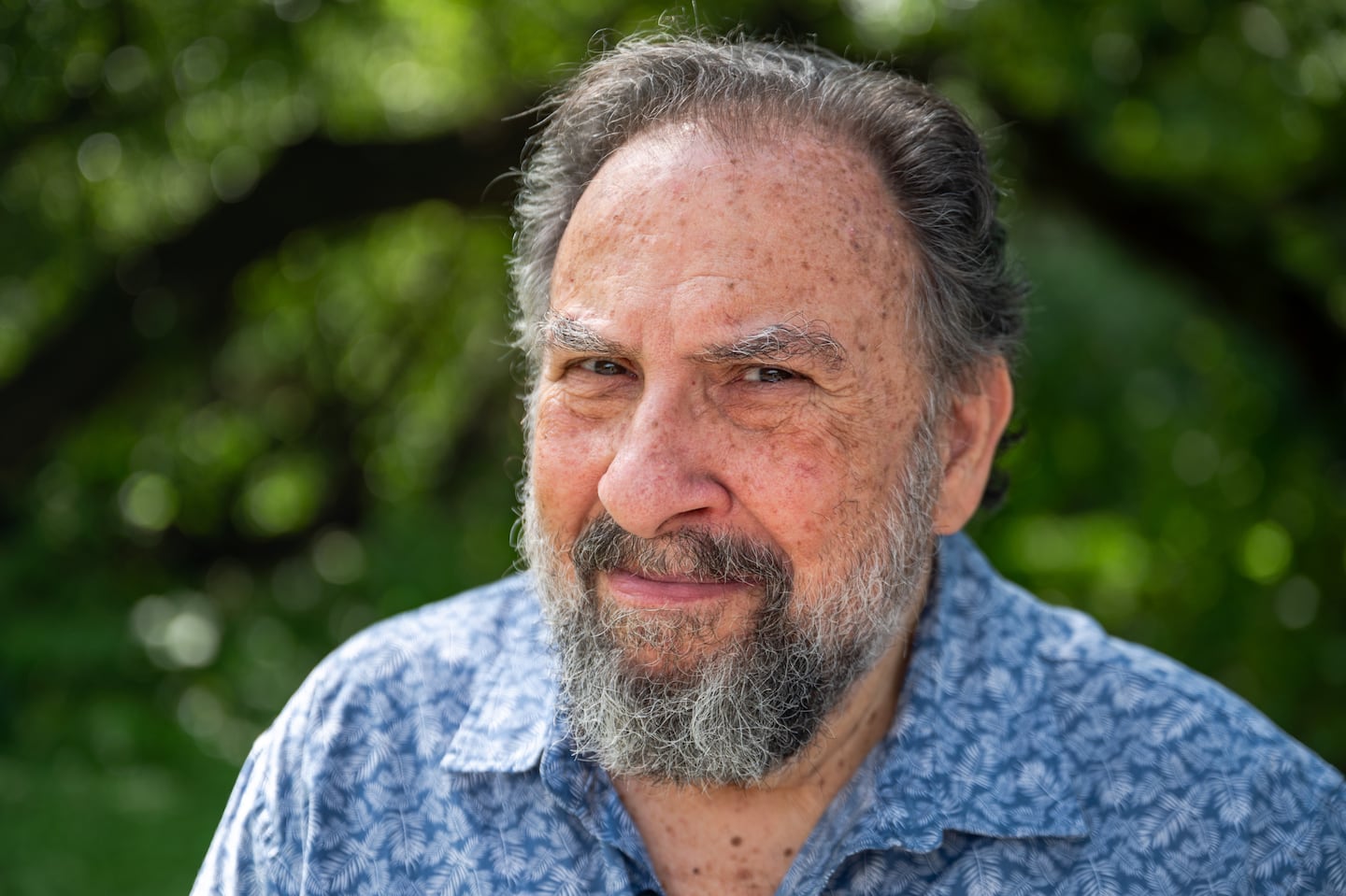 Moshe Waldoks poses for a portrait during a walk along the Charles River in Allston in late August. Waldoks's one-man show, "You Can Live If They Let You," premieres at Boston Center for the Arts Sept. 12.