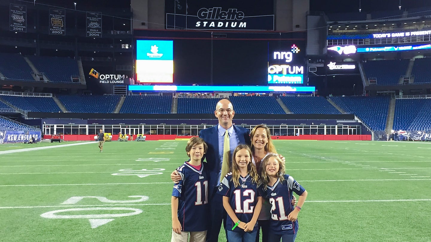 Dr. Mark Price with his family on the Gillette Stadium field on Aug. 13, 2015, after his first night with the New England Patriots medical team. With him are his wife, Stephanie, and their children, Henry, Julia, and Sarah.