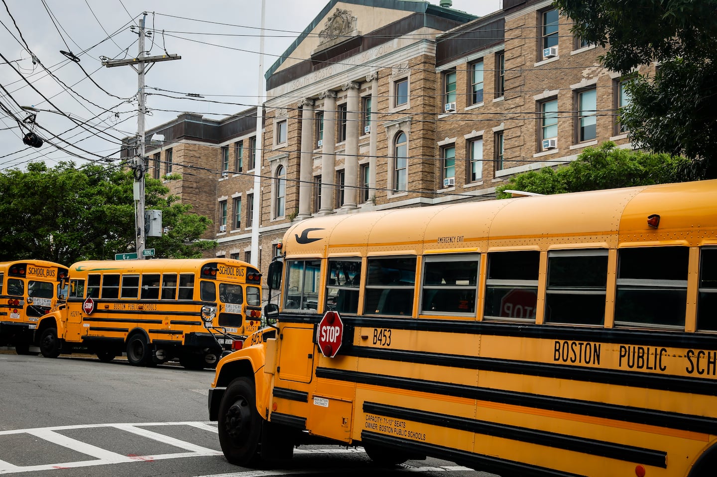 Buses lined up outside of Excel Academy (formerly South Boston High School) in South Boston at the end of a school day.