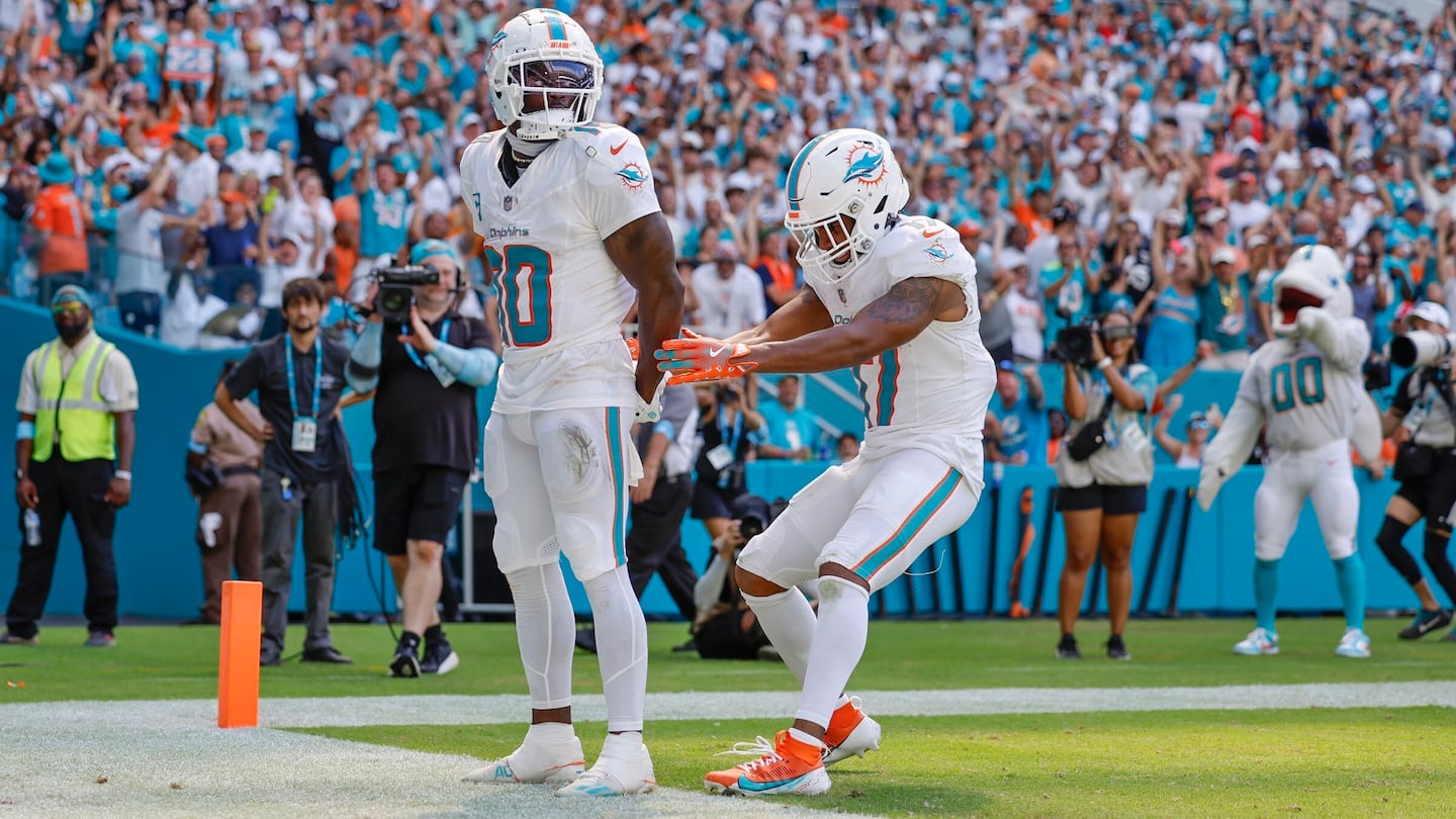 Tyreek Hill (left) mimicked his altercation with police after he scored a touchdown Sunday.