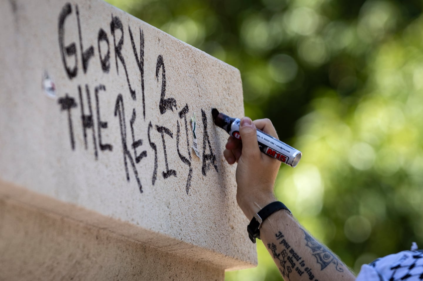 A pro-Palestinian activist wrote a graffiti message on the Rochambeau Statue in Lafayette Park next to the White House during a demonstration protesting the war in Gaza on June 8.