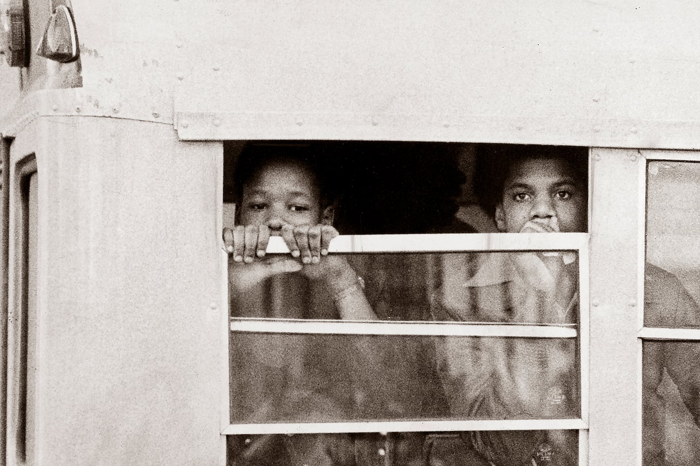 Boston, MA - 1/8/1975: Two students wait on a school bus before being admitted to South Boston High School in Boston on Jan. 8, 1975. An initiative to desegregate Boston Public Schools was implemented in the fall of 1974 and was met with strong resistance from many residents of Boston's neighborhoods. (Jack O'Connell/Globe Staff) --- BGPA Reference: 140710_CB_040