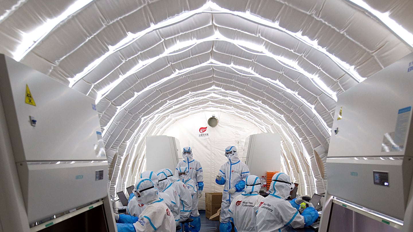 In this file photo released by China's Xinhua News Agency, staff members worked in an inflatable COVID-19 testing lab provided by Chinese biotech company BGI Genomics, a subsidiary of BGI Group, in Beijing, in 2020. BGI Group is one of several companies that would be affected by the legislation passed by the House.