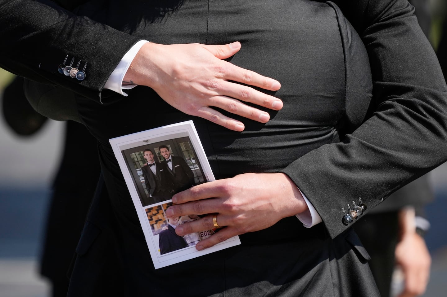 Mourners embrace while departing the funeral for Matthew and Johnny Gaudreau on Monday.