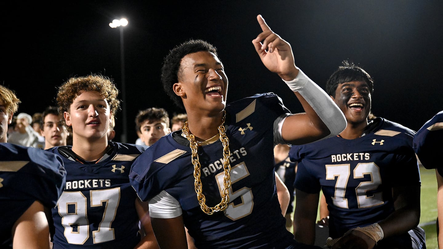 After scoring three touchdowns against Milton, Needham’s Aidan Williams (center) was sporting some extra bling. Needham opened the new season with a 24-0 victory.