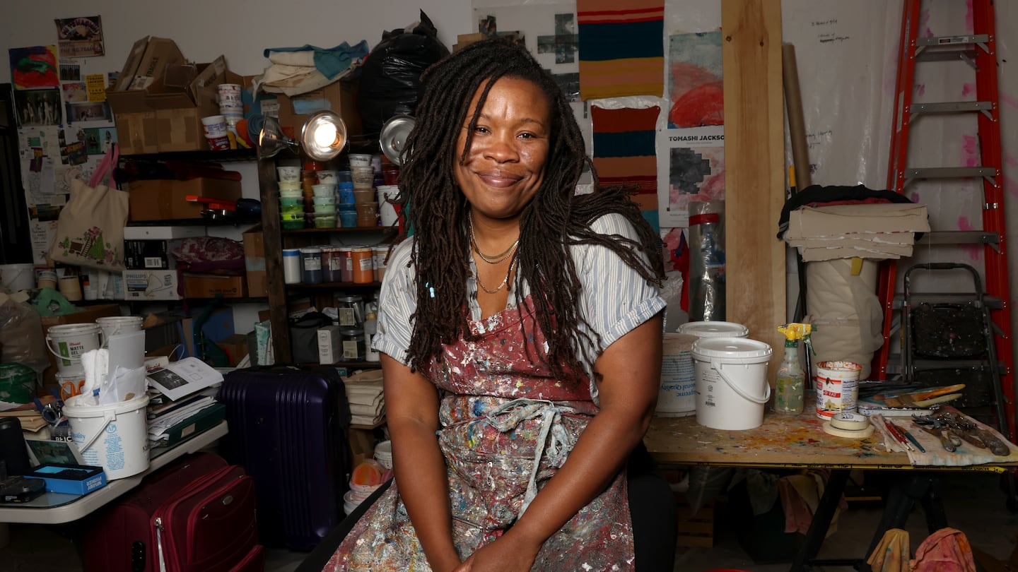 Artist Tomashi Jackson photographed at her Somerville studio. She has a solo show, "Across the Universe," at Tufts University Art Galleries, featuring her prints, sculptures, paintings, videos, and textiles.