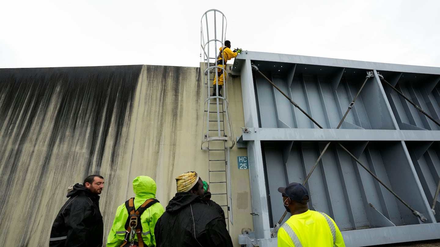 Workers from the Southeast Louisiana Flood Protection Authority-West close floodgates along the Harvey Canal, just outside the New Orleans city limits, in anticipation of Tropical Storm Francine, in Harvey, La., on Sept. 10.