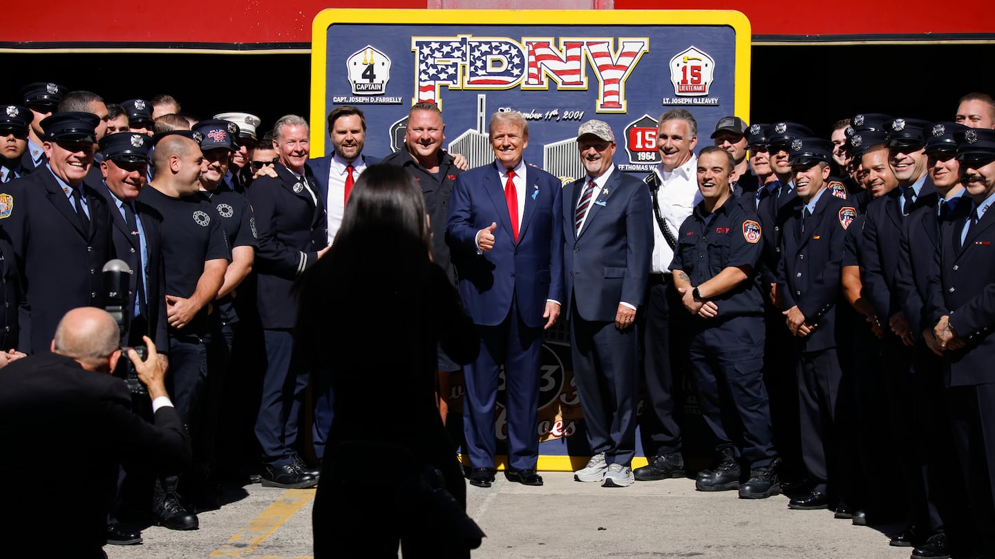 Republican presidential nominee former president Donald Trump, center and Republican vice presidential nominee Senator JD Vancepose for a photo with firefighters from Engine 4 Ladder 15 on the 23rd anniversary of the Sept. 11, 2001 terror attacks, Wednesday, Sept. 11, 2024, in New York.