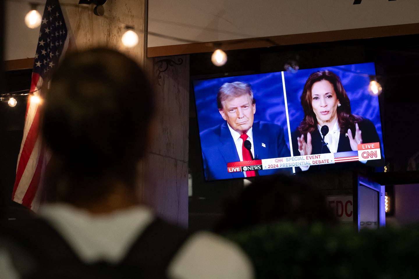 A person watched a screen displaying the presidential debate at The Admiral in Washington, D.C., Tuesday night.