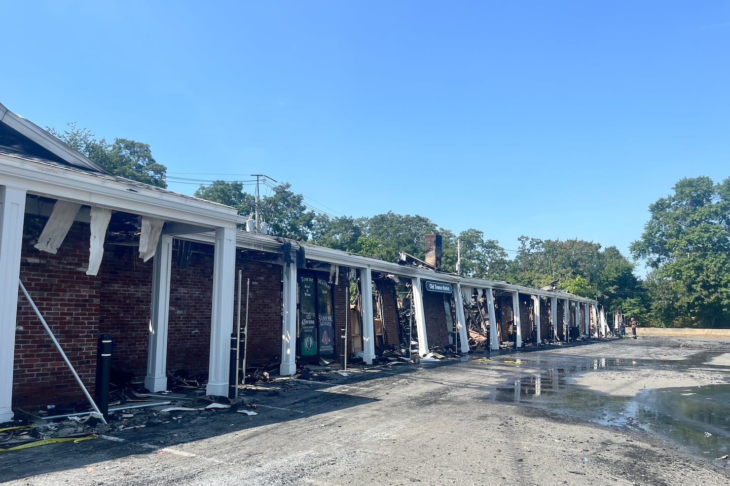 The charred remnants of the Post Office Square shopping center in Lynnfield on Wednesday.