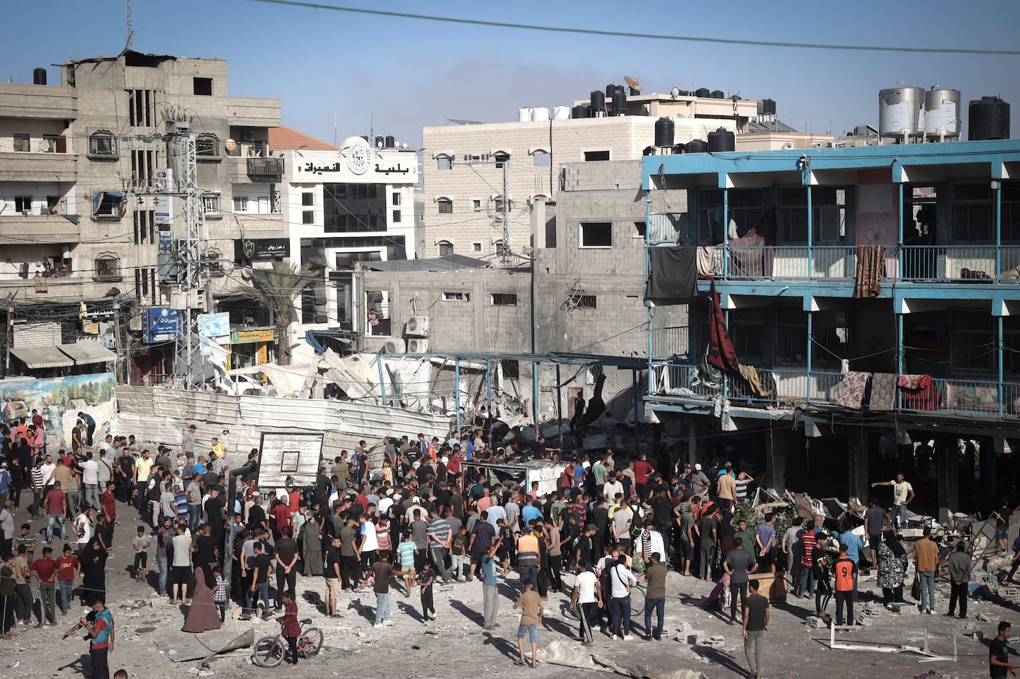 Palestinians stood in the courtyard of a school after an Israeli air strike hit the site in Nuseirat in the central Gaza Strip on Wednesday.