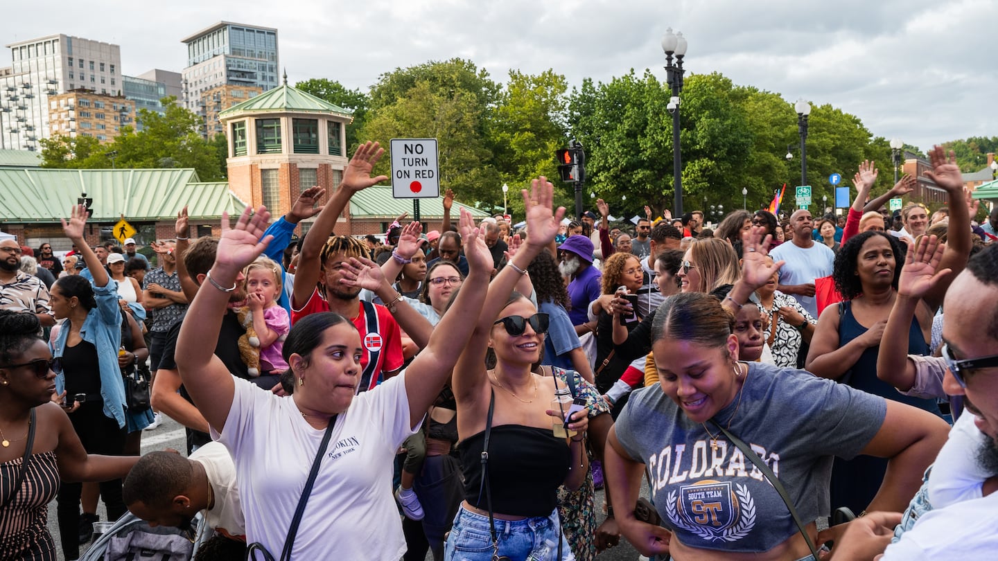 People wave their hands during Denis Graca’s performance at PVDFest in downtown Providence, R.I., on Saturday, Sept. 7.