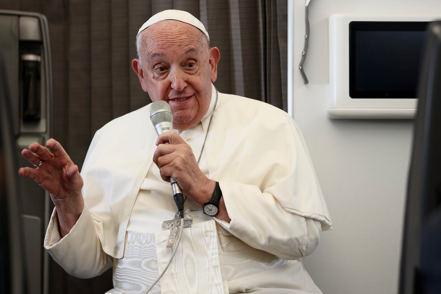 Pope Francis holds a news conference aboard the papal plane on his flight back after his 12-day journey across Southeast Asia and Oceania, Friday, Sept. 13, 2024.