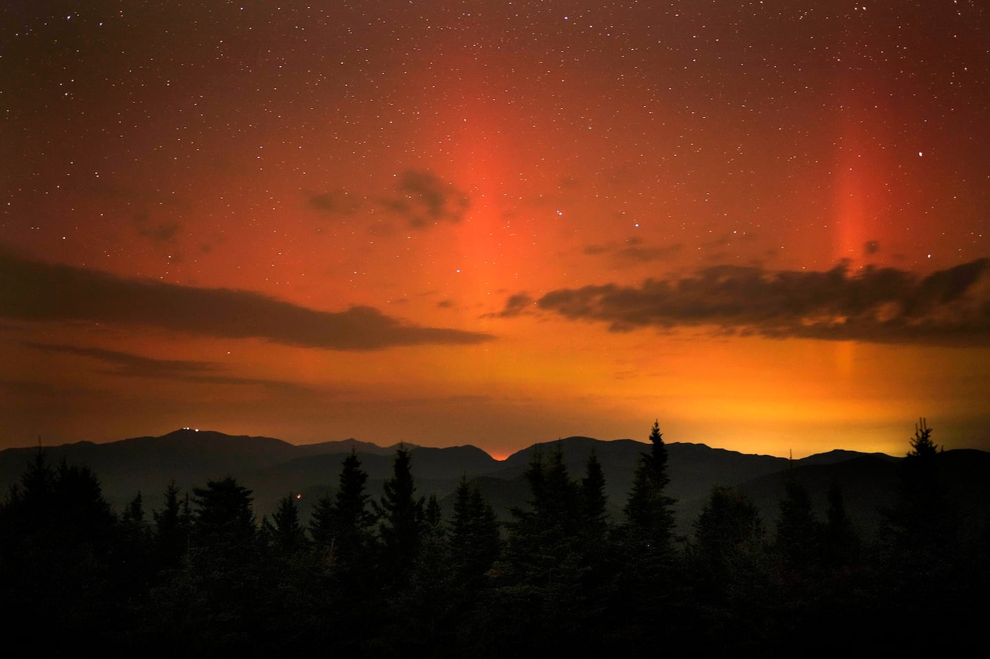 Flares of the Northern Lights color the sky just after midnight Friday as viewed from a mountaintop in Chatham, N.H.