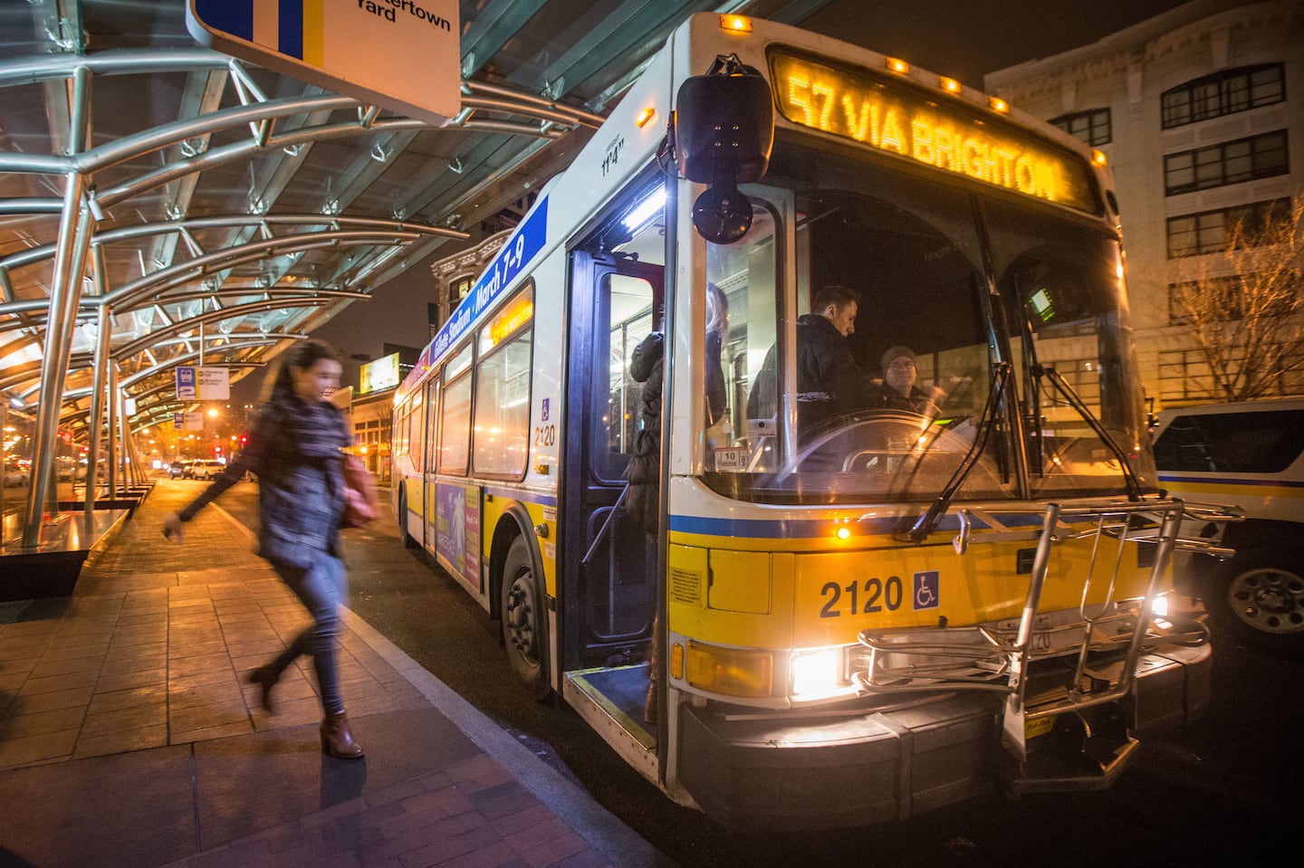 A person rushed to catch the 57 bus at 2:25 a.m. at Kenmore Station during one of the T's experiments with late-night service.