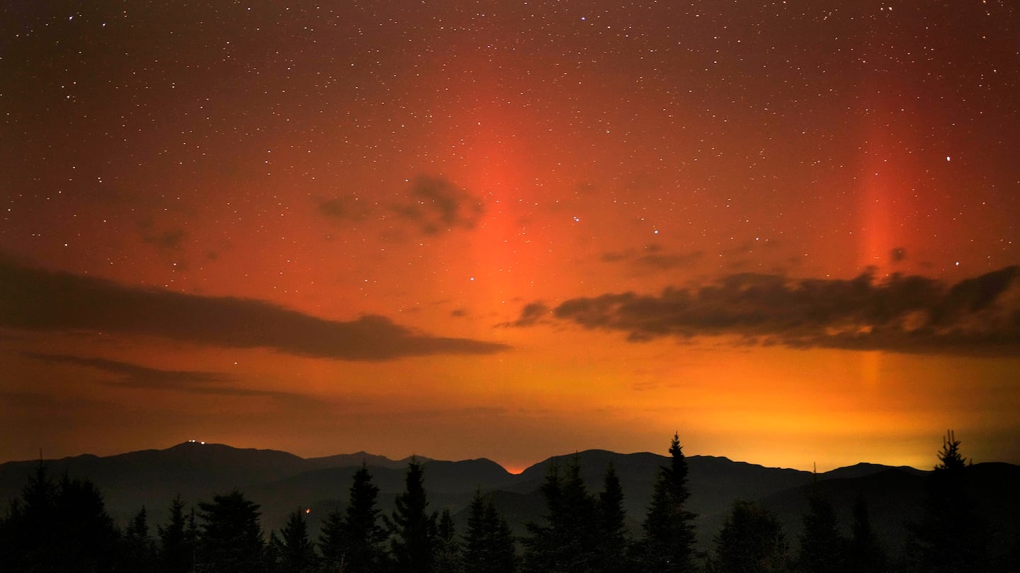 Flares of the Northern Lights color the sky just after midnight Friday as viewed from a mountaintop in Chatham, N.H.