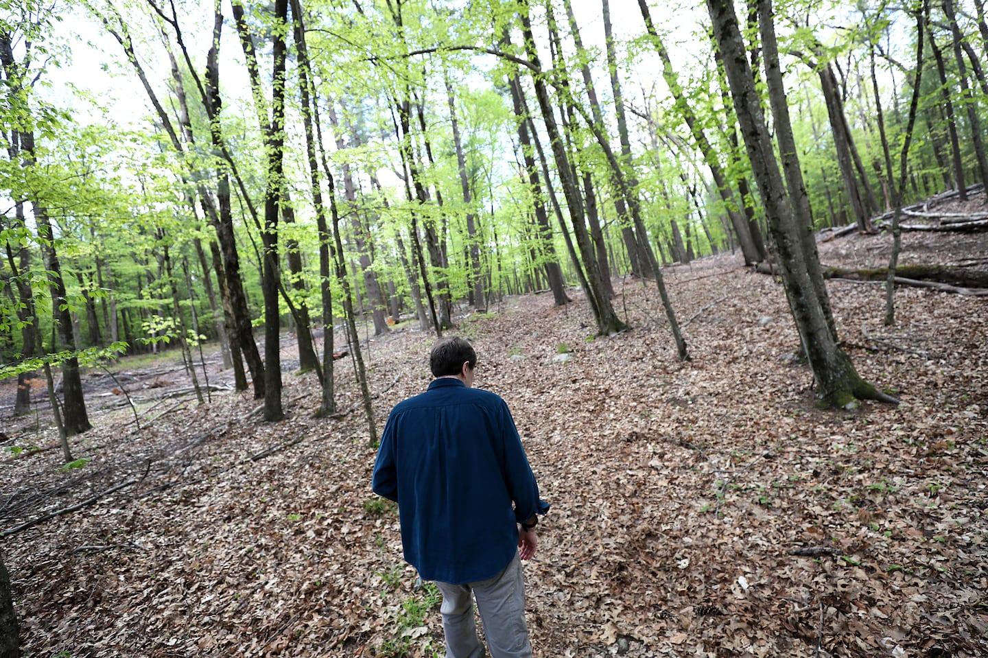 Tony Downs, who has early onset Alzheimer’s disease, took a walk in the woods near his house.