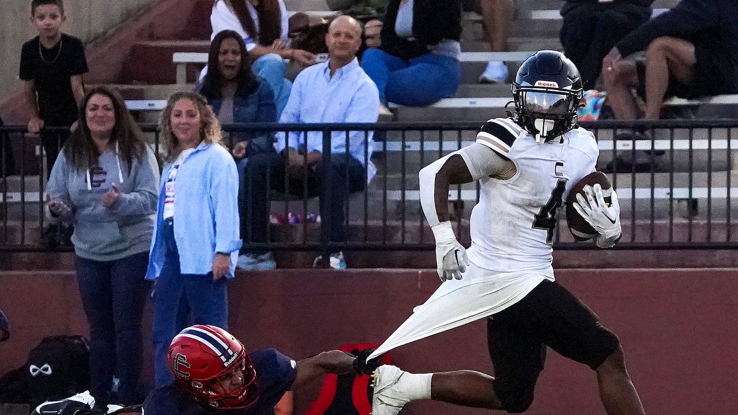 Central Catholic's Jomar Berrios, (No. 1) tries to make a diving tackle on Springfield Central's Ja'Cyion Cox, who proved unstoppable in a 42-20 nonleague win over the No. 8 Raiders in Lawrence on Saturday night.