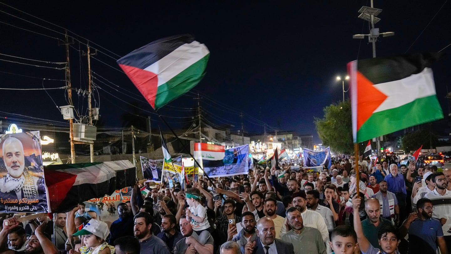 People chanted slogans while waving Palestinians flags during a rally in Baghdad, Iraq, on Aug. 3, to show support for Palestinians in Gaza.