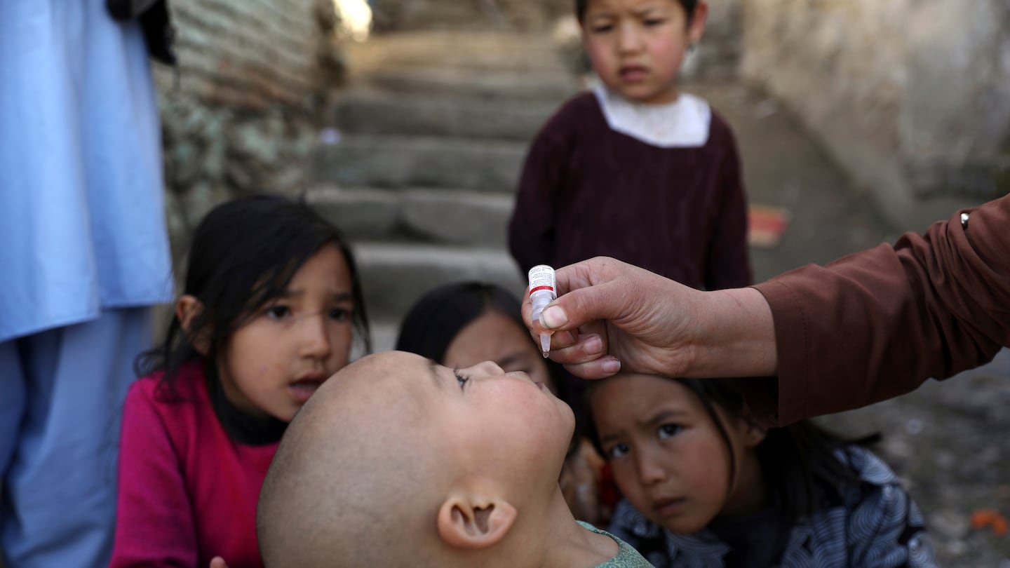 Shabana Maani gives a polio vaccination to a child in the old part of Kabul, Afghanistan, Monday, March 29, 2021.