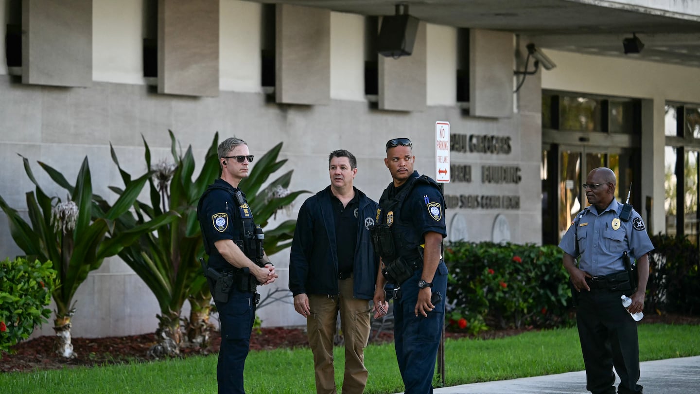 Security and law enforcement officials stand outside the Paul G. Rogers Federal Building and US Courthouse, where Ryan Wesley Routh, the suspect in an apparent assasination attempt on former president Donald Trump, appears in court on Sept. 16, 2024 in West Palm Beach, Florida.