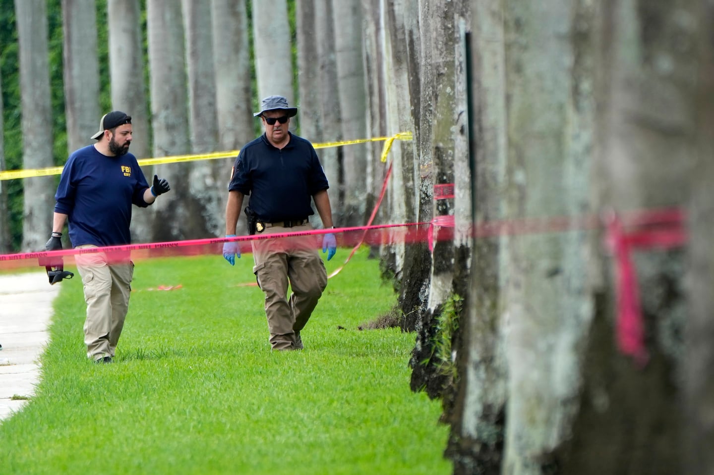 Law enforcement officials worked outside of the Trump International Golf Club after the apparent assassination attempt of Republican presidential nominee and former president Donald Trump on Monday in West Palm Beach, Fla.