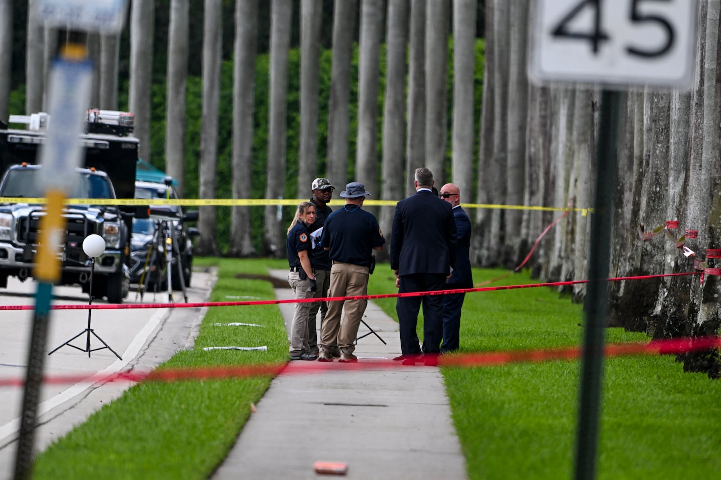 Law enforcement officials work at the crime scene outside the Trump International Golf Club in West Palm Beach, Fla., on Sept. 16, 2024, following Sunday's attempted assassination on former president Donald Trump.