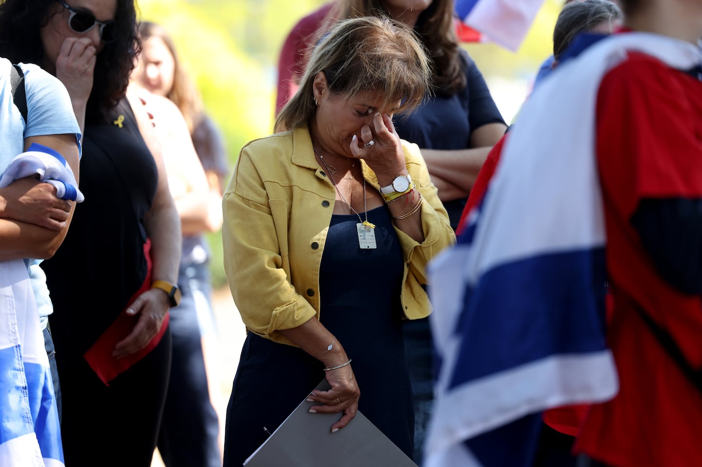 Dr. Mira Zinger, a personal family friend of Carmel Gat, wiped tears away after speaking about Gat, who was one of the hostages killed by Hamas, during a rally at the Newton Centre Green on Sept. 15 in support of bringing home the Israeli hostages being held by Hamas.