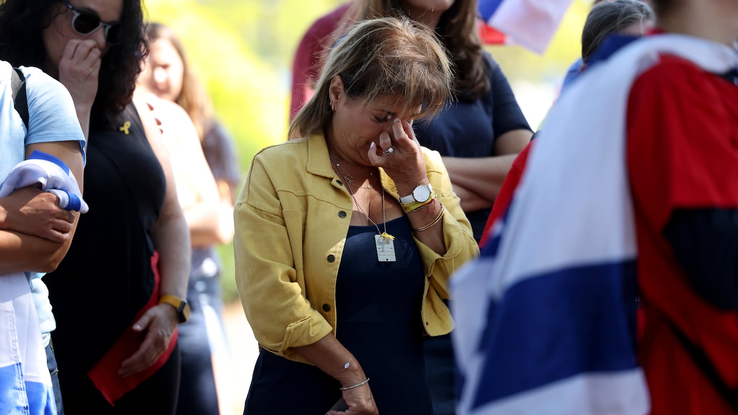 Dr. Mira Zinger, a personal family friend of Carmel Gat, wiped tears away after speaking about Gat, who was one of the hostages killed by Hamas, during a rally at the Newton Centre Green on Sept. 15 in support of bringing home the Israeli hostages being held by Hamas.