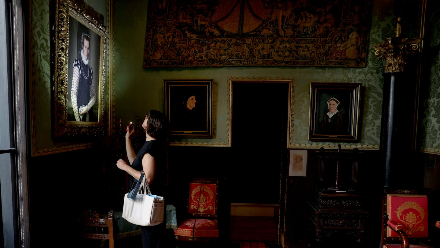 Lucia Bay, associate paintings conservator at the Isabella Stewart Gardner Museum, looking at a painting with her flashlight in the Dutch Room.