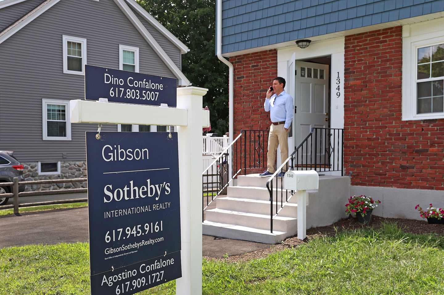 Realtor Dino Confalone waited to show a Braintree home to a client in August. The median price for a single-family home inched down slightly last month, though it's still higher than last year.